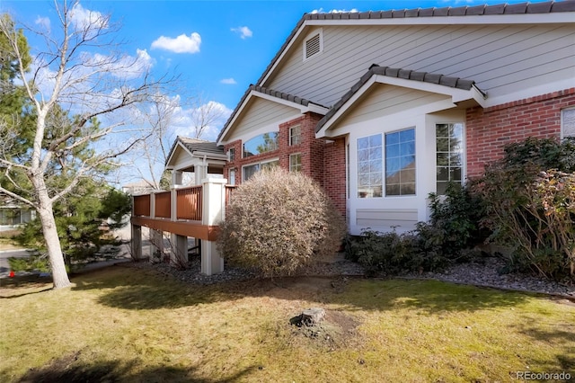 view of side of property with a yard