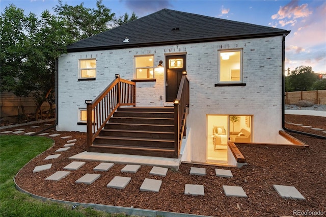 view of back house at dusk