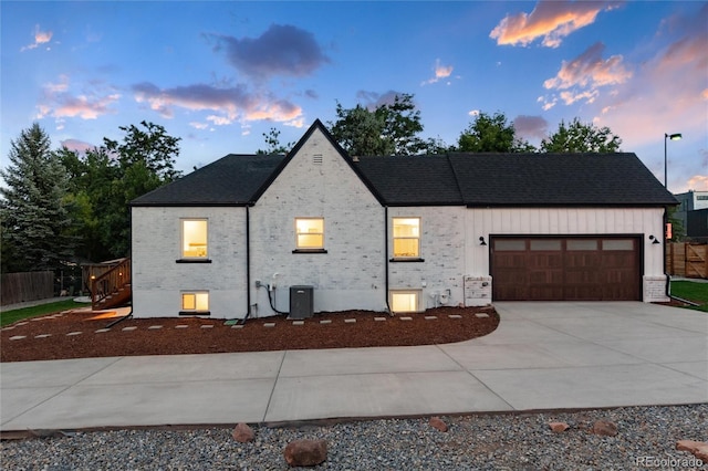 view of front of house featuring a garage and central AC unit