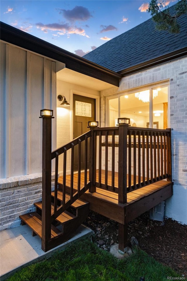 exterior entry at dusk featuring a deck