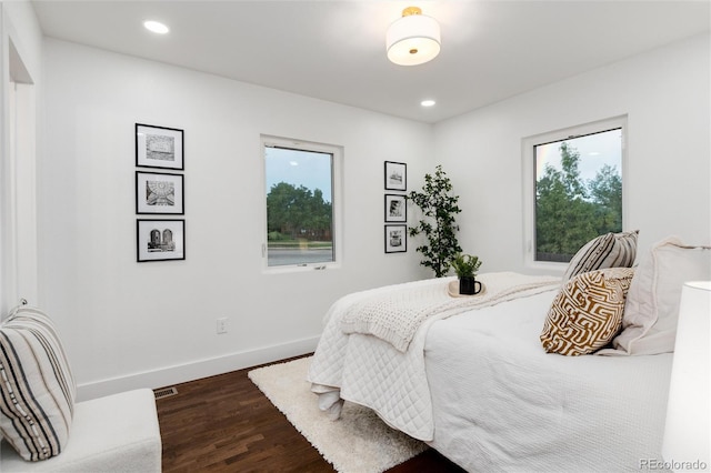 bedroom with dark hardwood / wood-style floors