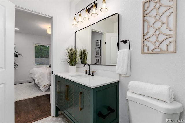 bathroom with vanity, hardwood / wood-style floors, and toilet