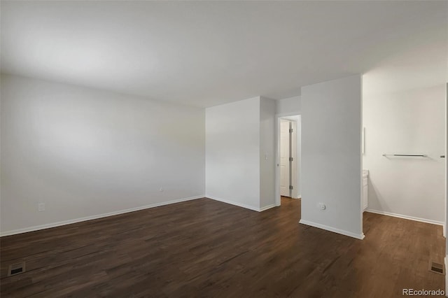 empty room featuring dark hardwood / wood-style flooring