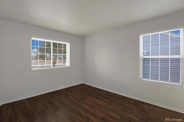 unfurnished room featuring dark hardwood / wood-style flooring