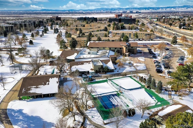 snowy aerial view with a mountain view