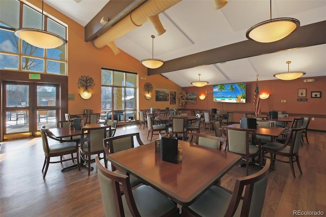 dining area with dark hardwood / wood-style flooring, lofted ceiling with beams, and french doors