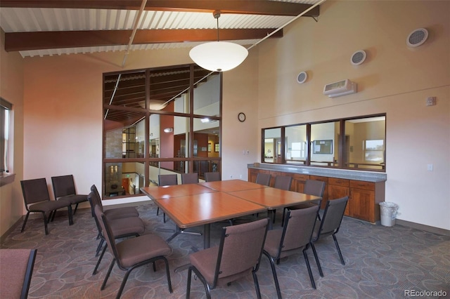 dining area with a towering ceiling