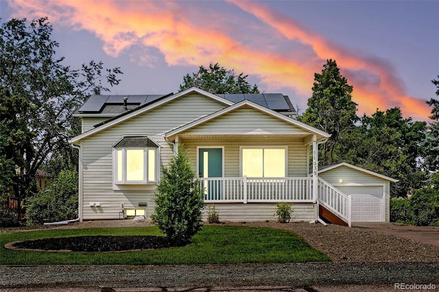 11635 W Security Ave, Lakewood, CO 80401 - bungalow-style house featuring a porch, roof mounted solar panels, a yard, and concrete driveway
