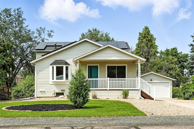 11635 W Security Ave, Lakewood, CO 80401 - view of front of property with a porch, concrete driveway, an outdoor structure, solar panels, and a front yard