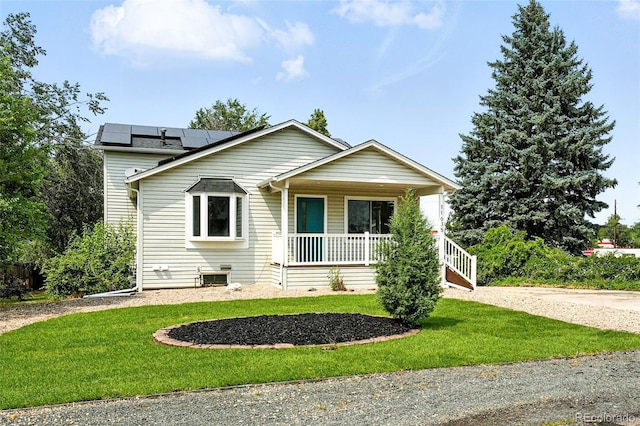 11635 W Security Ave, Lakewood, CO 80401 - view of front of property with covered porch, a front lawn, and roof mounted solar panels