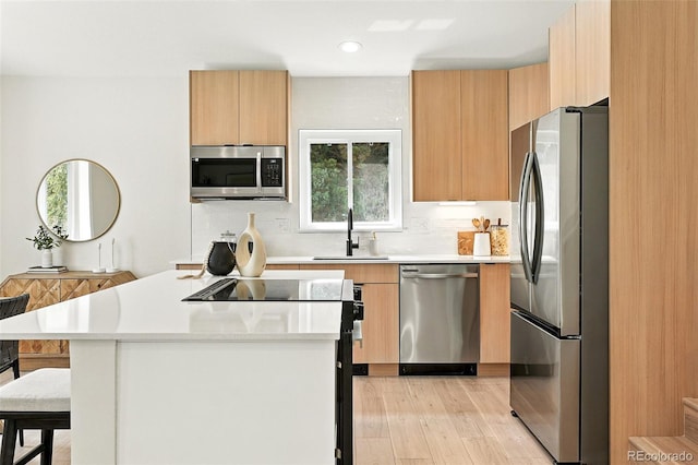 11635 W Security Ave, Lakewood, CO 80401 - kitchen with appliances with stainless steel finishes, a breakfast bar, light countertops, modern cabinets, and recessed lighting