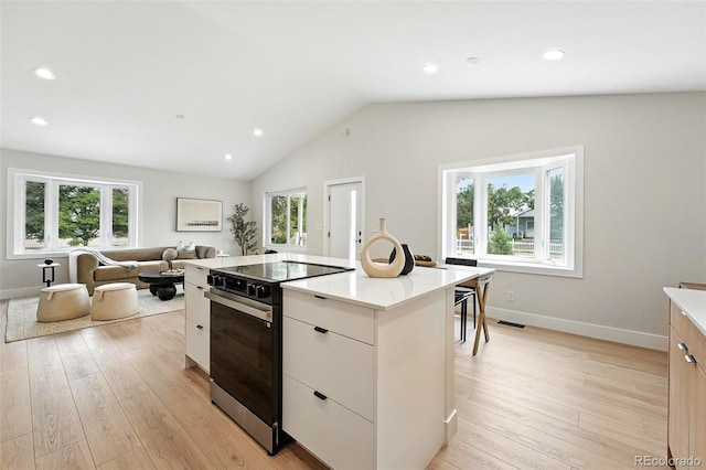11635 W Security Ave, Lakewood, CO 80401 - kitchen featuring range with electric cooktop, a kitchen island, healthy amount of natural light, light countertops, and recessed lighting