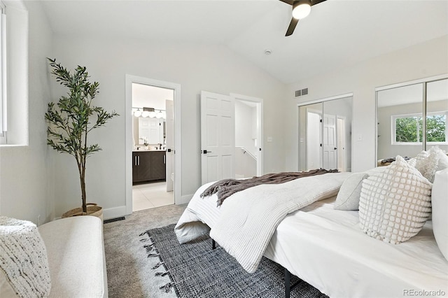 11635 W Security Ave, Lakewood, CO 80401 - bedroom with multiple closets, light colored carpet, vaulted ceiling, ensuite bath, and ceiling fan