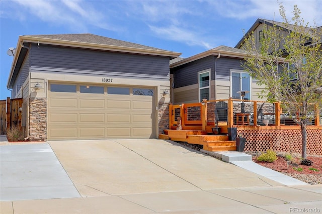 view of front of property with driveway and stone siding