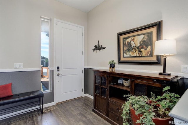 entryway featuring baseboards and wood finished floors