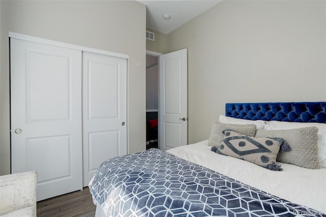 bedroom featuring visible vents, wood finished floors, and a closet