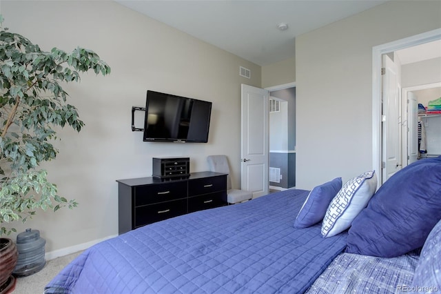 carpeted bedroom featuring baseboards and visible vents