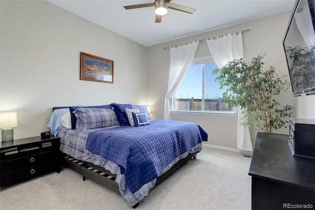 bedroom featuring baseboards, a ceiling fan, and light carpet