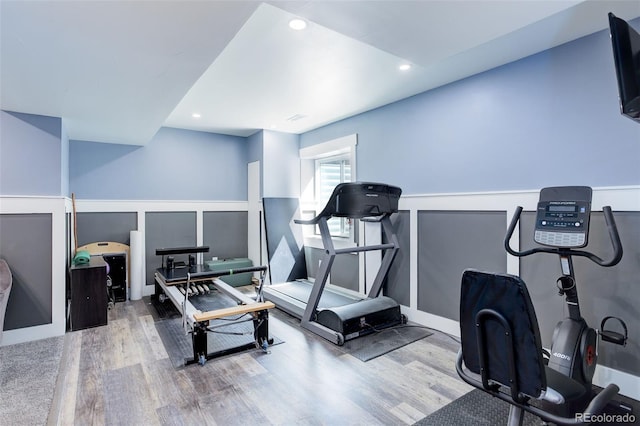workout room with recessed lighting, visible vents, wainscoting, and wood finished floors