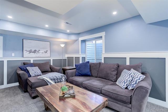 living area featuring visible vents, recessed lighting, and light carpet