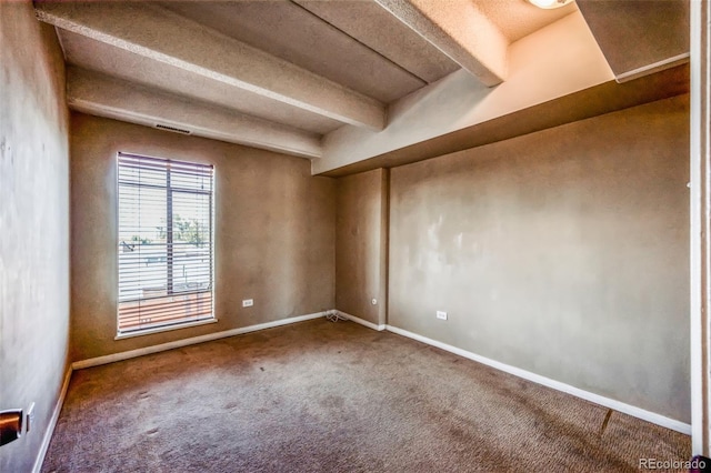 unfurnished room with beamed ceiling, visible vents, baseboards, and carpet floors