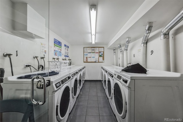 common laundry area with separate washer and dryer and dark tile patterned flooring