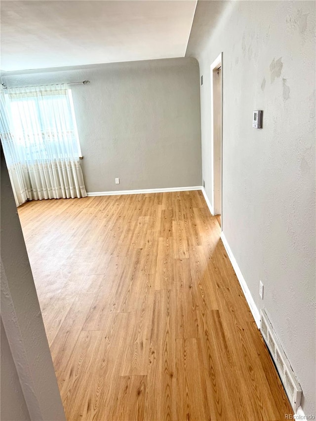 empty room with light hardwood / wood-style floors