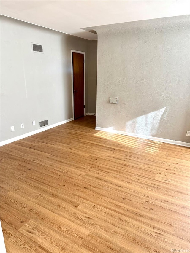 spare room featuring light wood-type flooring