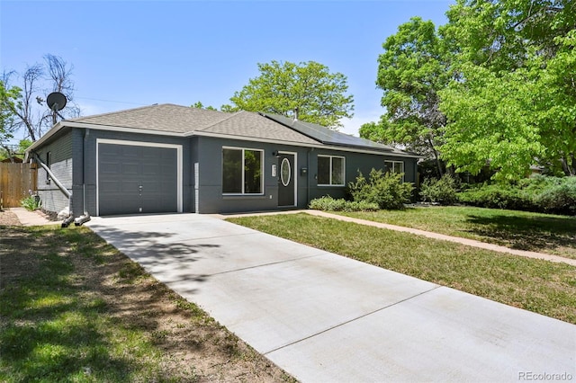 971 Ursula St, Aurora, CO 80011 - single story home featuring a garage, solar panels, and concrete driveway