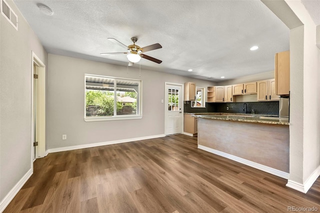 971 Ursula St, Aurora, CO 80011 - kitchen with light brown cabinets, ceiling fan, dark wood finished floors, a sink, and a peninsula