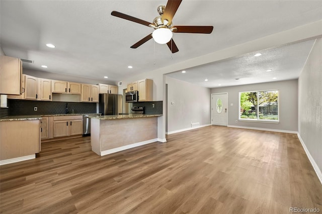 971 Ursula St, Aurora, CO 80011 - kitchen featuring stainless steel appliances, light brown cabinets, backsplash, ceiling fan, and recessed lighting