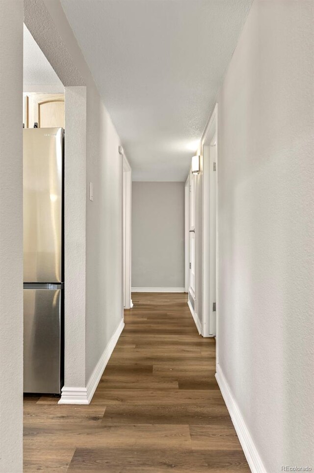971 Ursula St, Aurora, CO 80011 - corridor featuring baseboards and wood finished floors