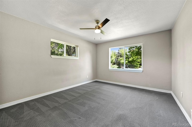 971 Ursula St, Aurora, CO 80011 - spare room featuring healthy amount of natural light, a ceiling fan, dark colored carpet, and a textured ceiling