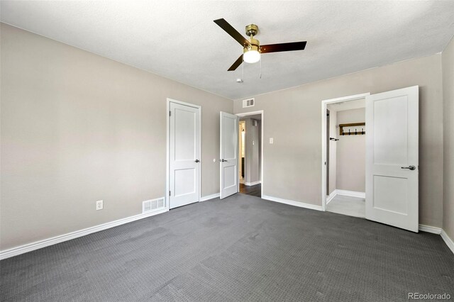 971 Ursula St, Aurora, CO 80011 - unfurnished bedroom featuring baseboards, dark colored carpet, and a ceiling fan