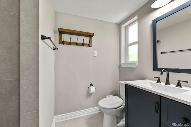 971 Ursula St, Aurora, CO 80011 - bathroom featuring toilet, vanity, and baseboards