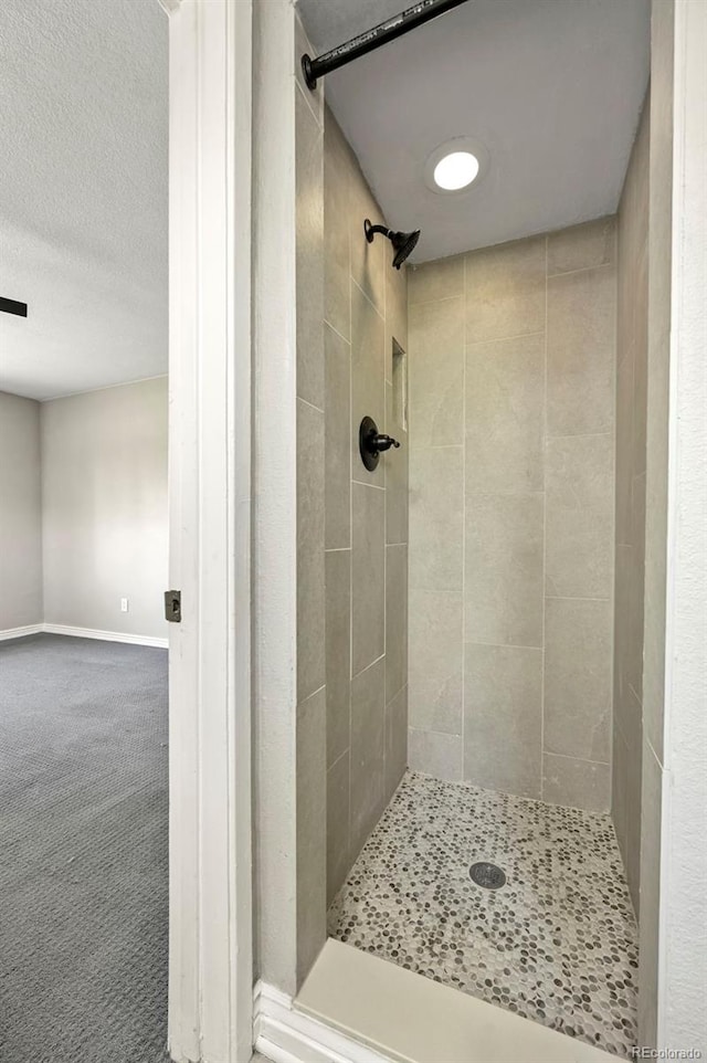 971 Ursula St, Aurora, CO 80011 - bathroom featuring a stall shower and baseboards