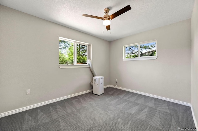 971 Ursula St, Aurora, CO 80011 - empty room with ceiling fan, carpet flooring, baseboards, and a textured ceiling