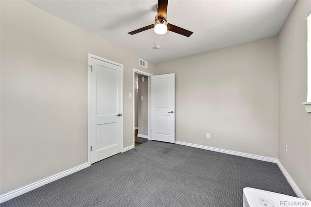 971 Ursula St, Aurora, CO 80011 - unfurnished bedroom featuring dark colored carpet, baseboards, and a ceiling fan