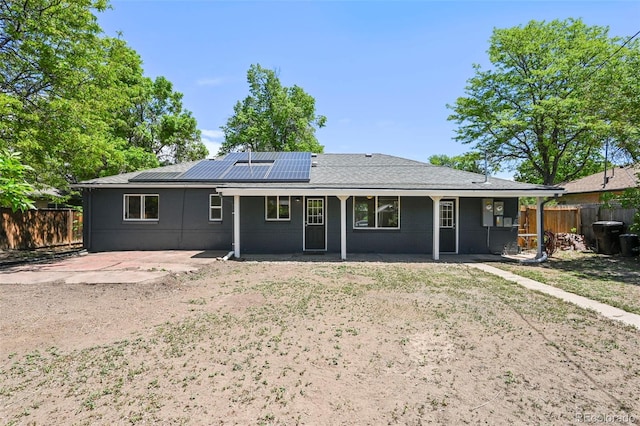 971 Ursula St, Aurora, CO 80011 - rear view of property with roof mounted solar panels and a patio area