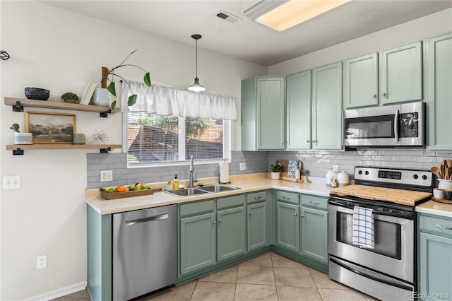 9630 Yukon Way, Colorado Springs, CO 80925 - kitchen with appliances with stainless steel finishes, green cabinetry, open shelves, and light countertops