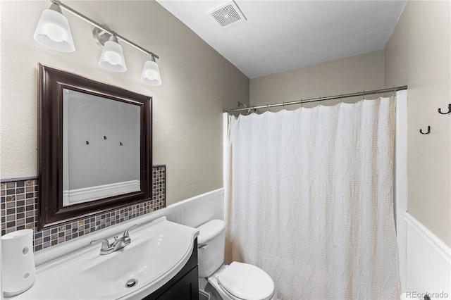 9630 Yukon Way, Colorado Springs, CO 80925 - full bath with vanity, wainscoting, and a shower with curtain