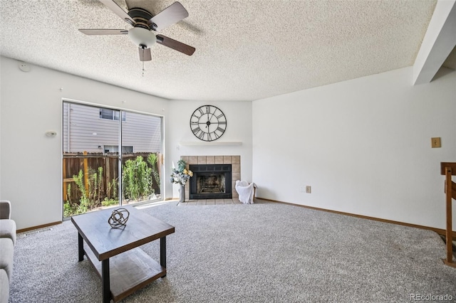 4220 Hunting Meadows Cir, Colorado Springs, CO 80916 - carpeted living area with a tile fireplace, ceiling fan, and a textured ceiling