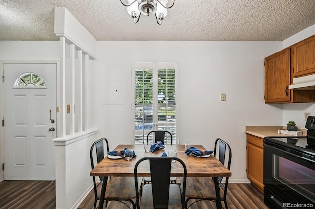 4220 Hunting Meadows Cir, Colorado Springs, CO 80916 - dining space with a textured ceiling, dark wood-style flooring, and a chandelier