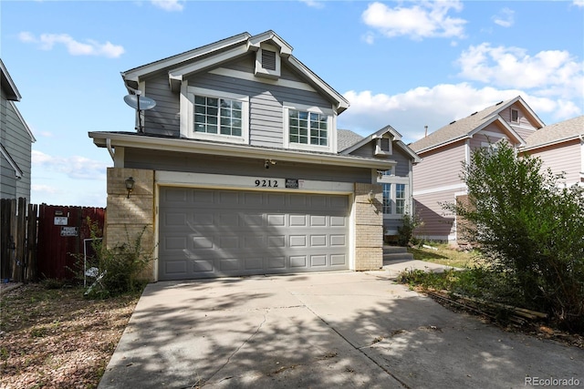 traditional home featuring brick siding, driveway, and an attached garage