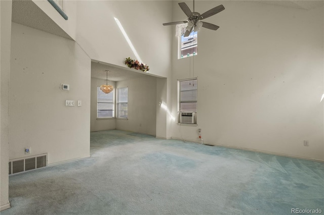 unfurnished room featuring a healthy amount of sunlight, visible vents, and carpet flooring