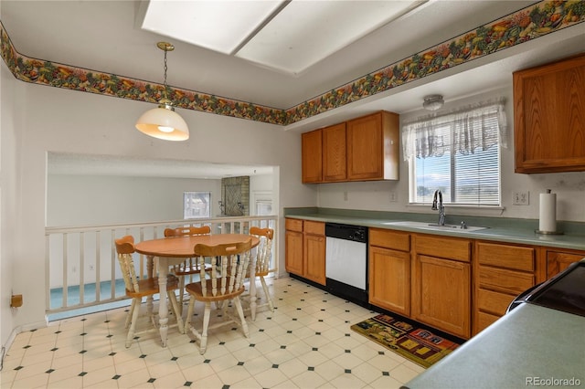 kitchen featuring pendant lighting, light floors, light countertops, a sink, and dishwasher