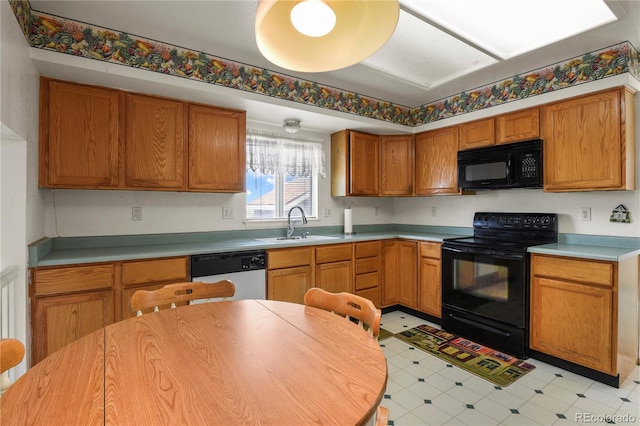 kitchen with brown cabinetry, light countertops, a sink, and black appliances