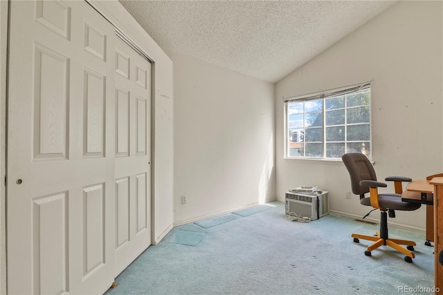 office area featuring light colored carpet, vaulted ceiling, a textured ceiling, and baseboards