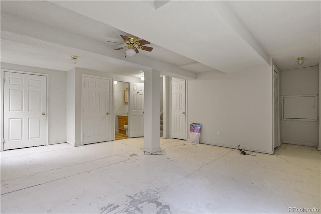 spare room featuring ceiling fan and stairway