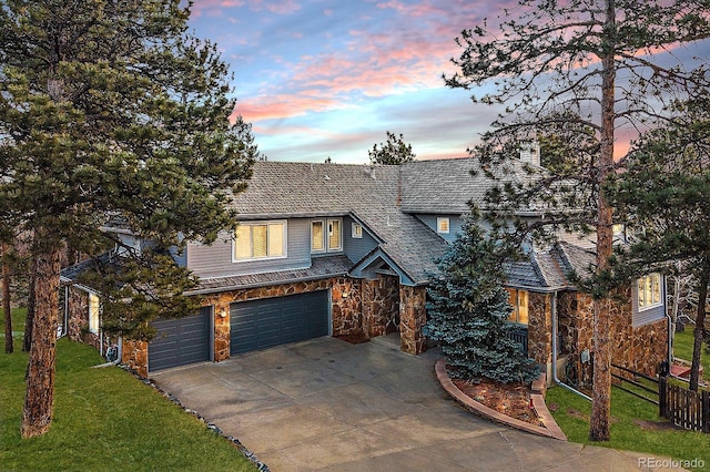 view of front of home with a garage and a yard